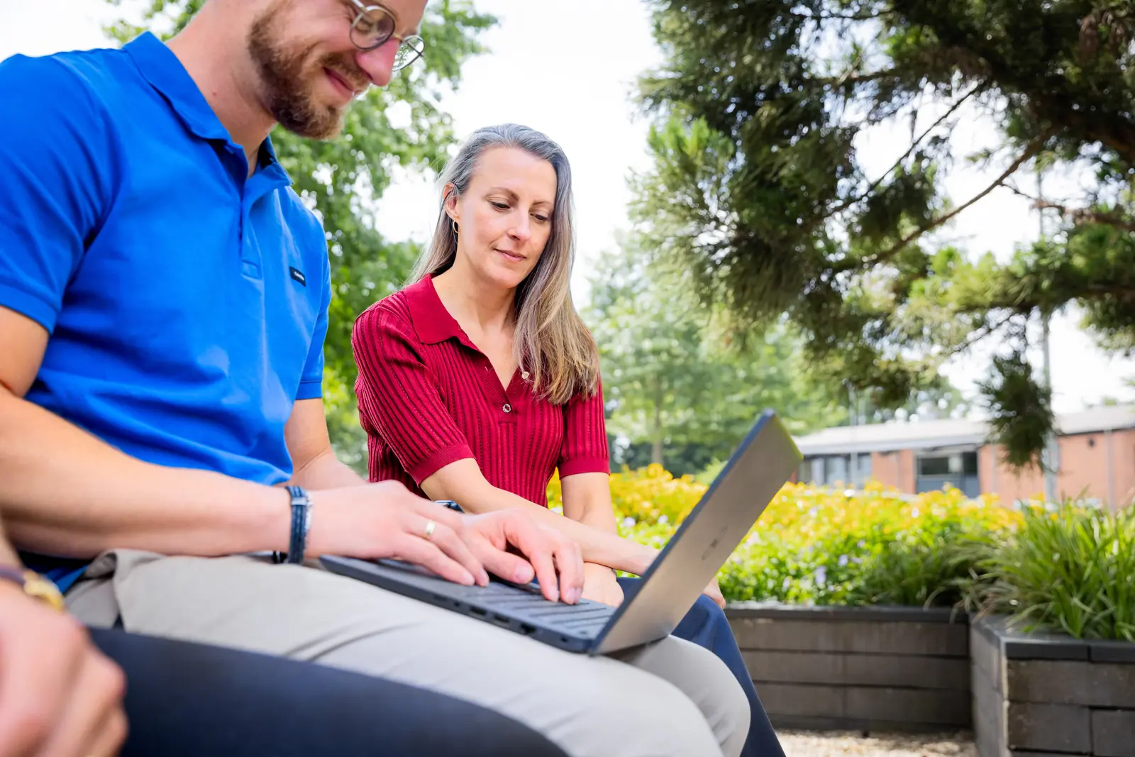 Man laptop op schoot plus vrouw